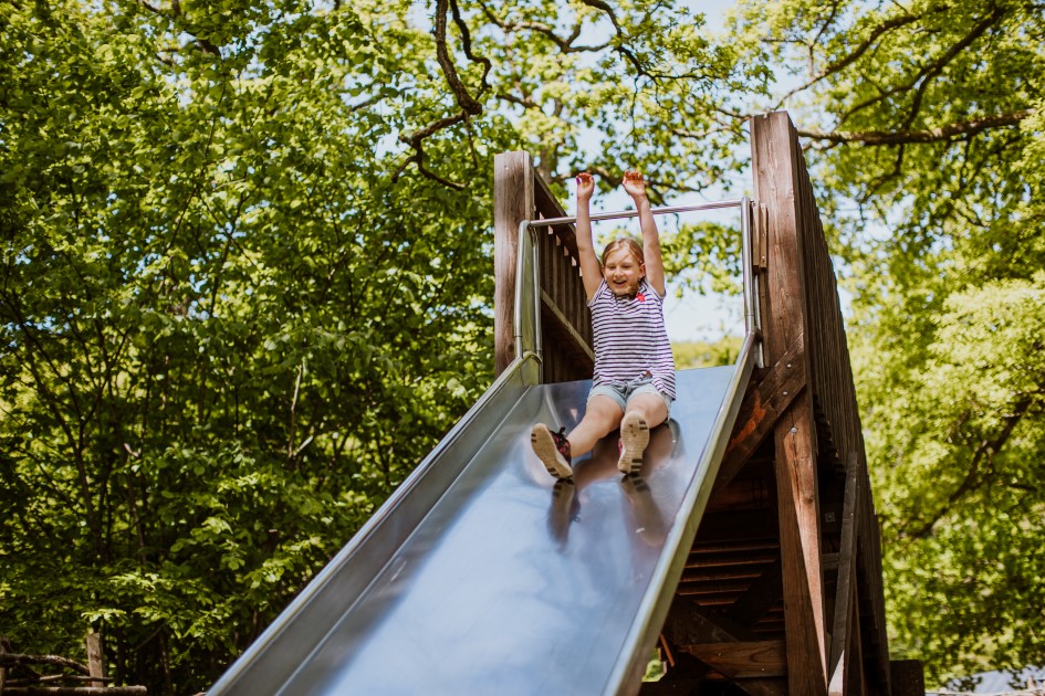 Girl going  down a slide