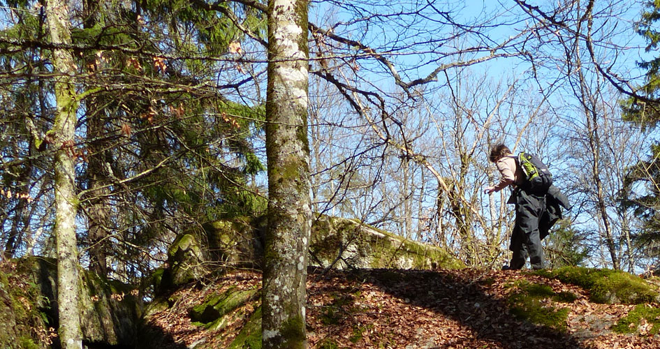 A hiker walks on a cliff.