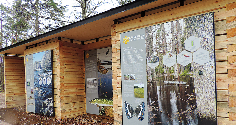 Information sign in wood with pictures and text on.