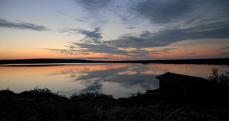 Pink twilight over mirror-shiny water.