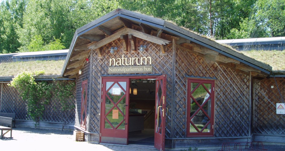 A brown wooden house, information center naturum.